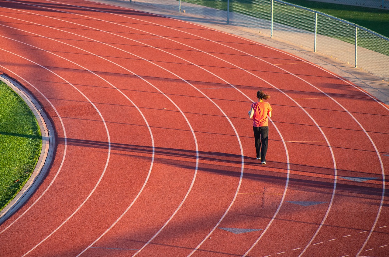 Running, woman, track — How Much Does Testosterone Cost?